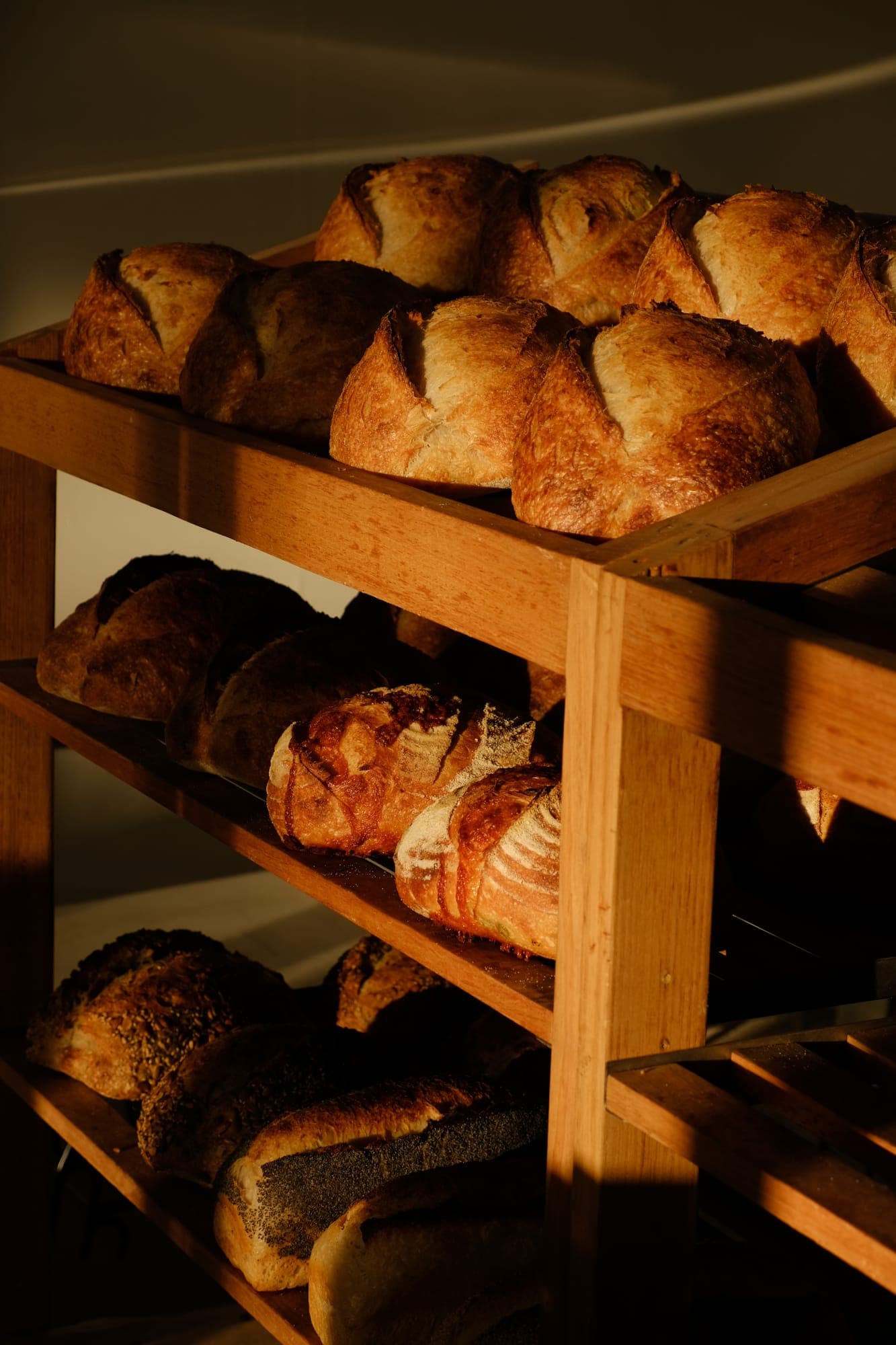 Shelves stacked with freshly baked sourdough loaves
