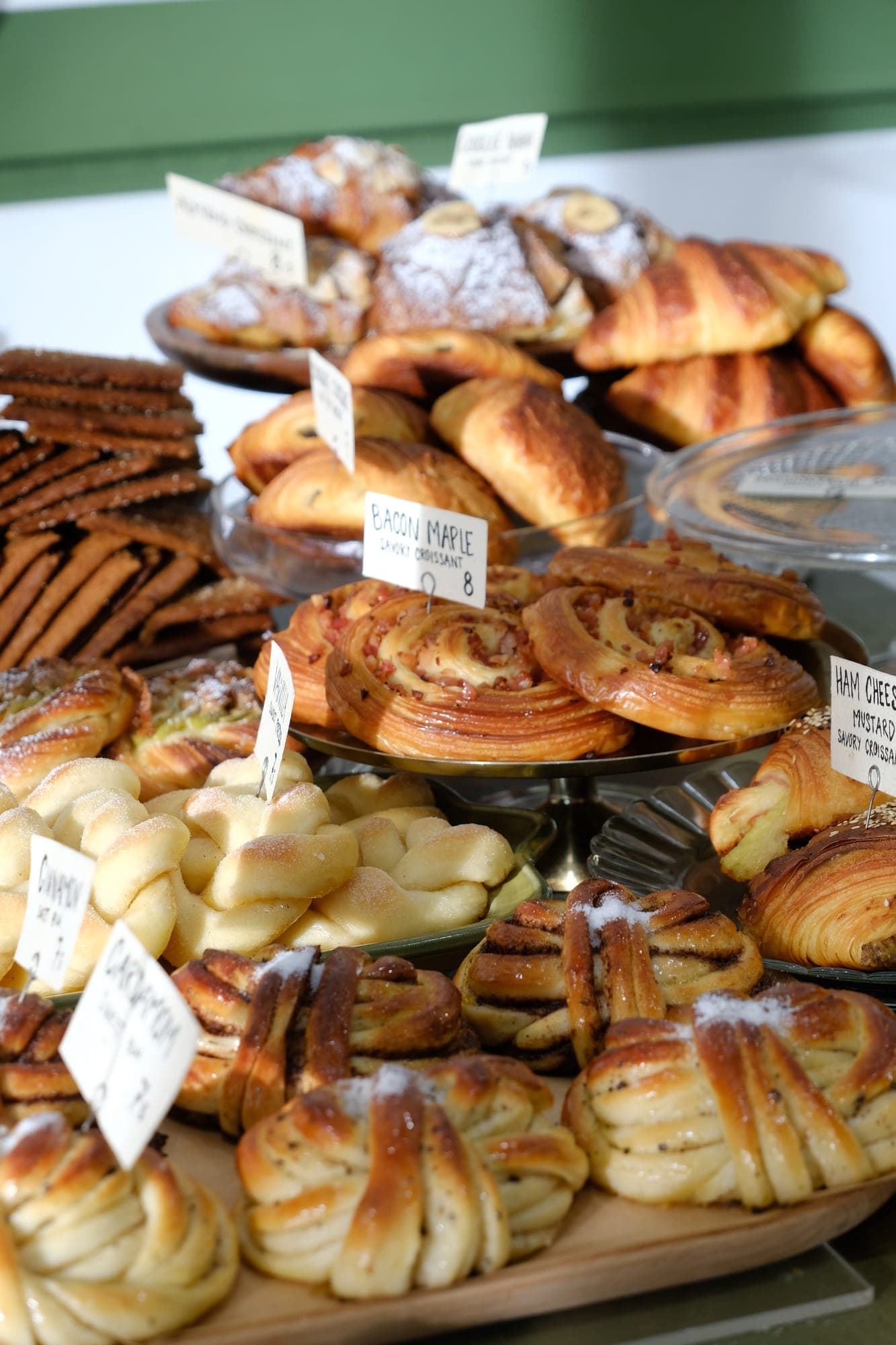 Counter filled with cardamom buns, cinnamon scrolls and croissants